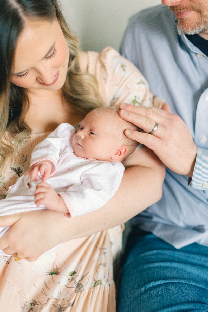 dad playing with newborn babys hair