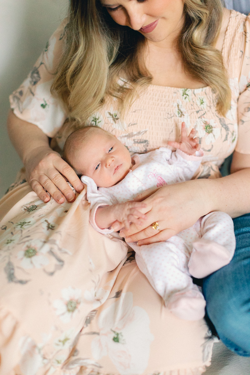 newborn baby in moms lap