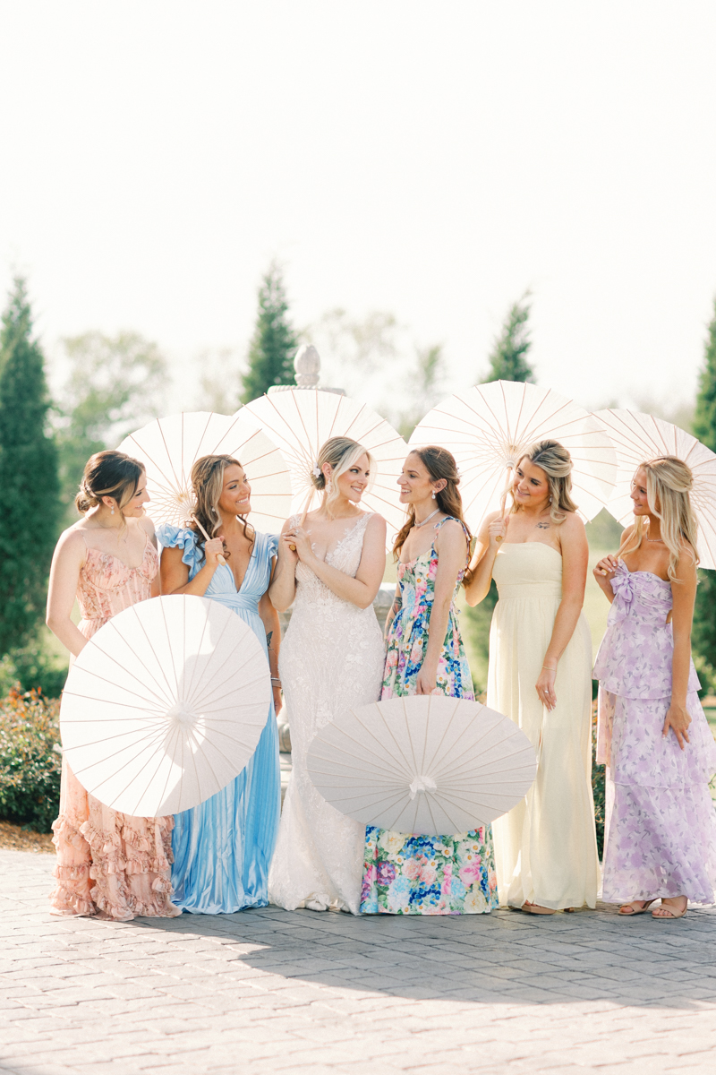 bride and bridesmaids holding parasols