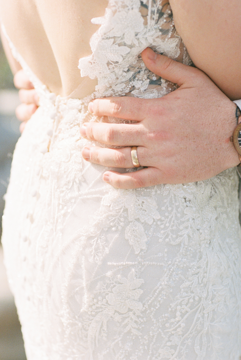 grooms hand on brides waist