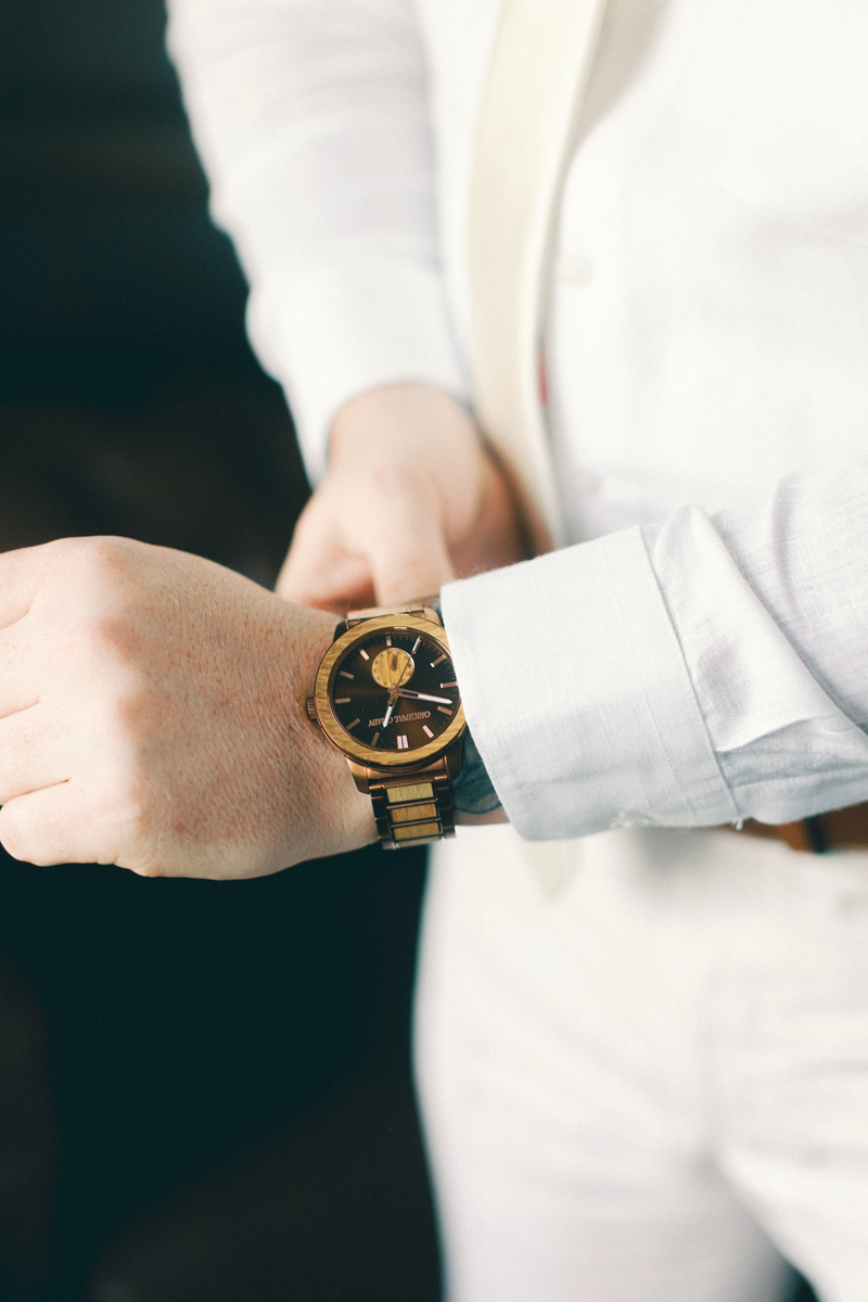 groom putting on watch