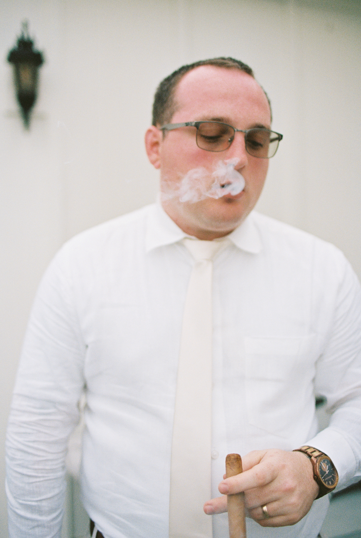 groom smoking a cigar