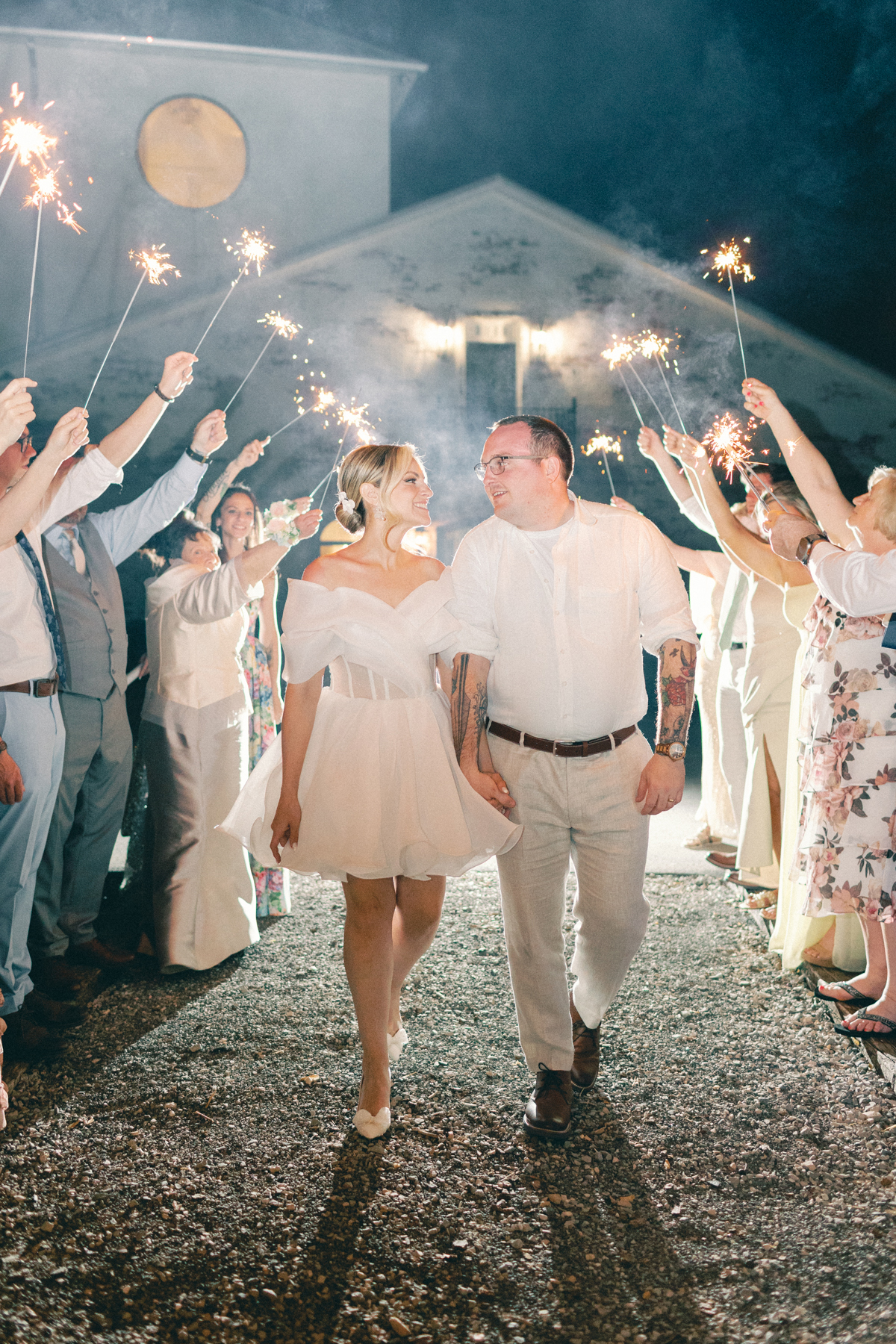 couple walking sparkler exit