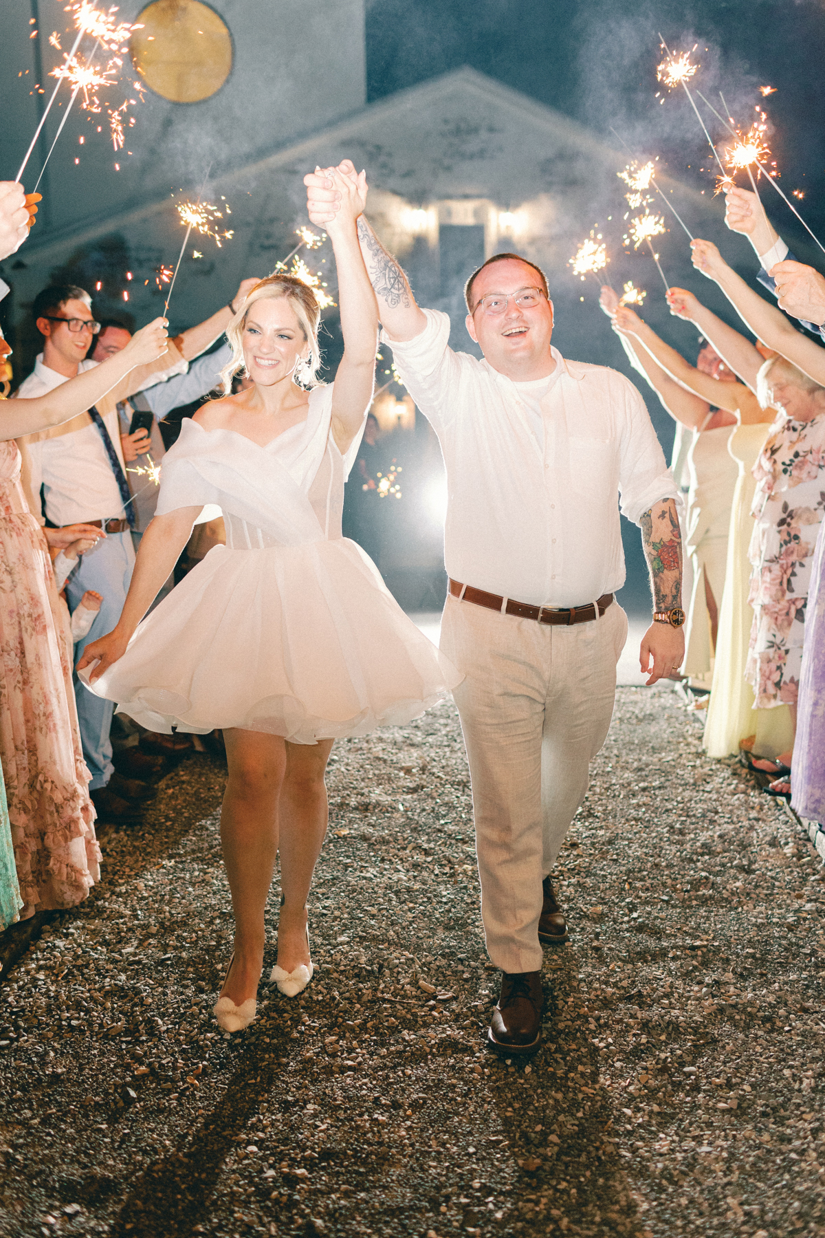 couple walking sparkler exit