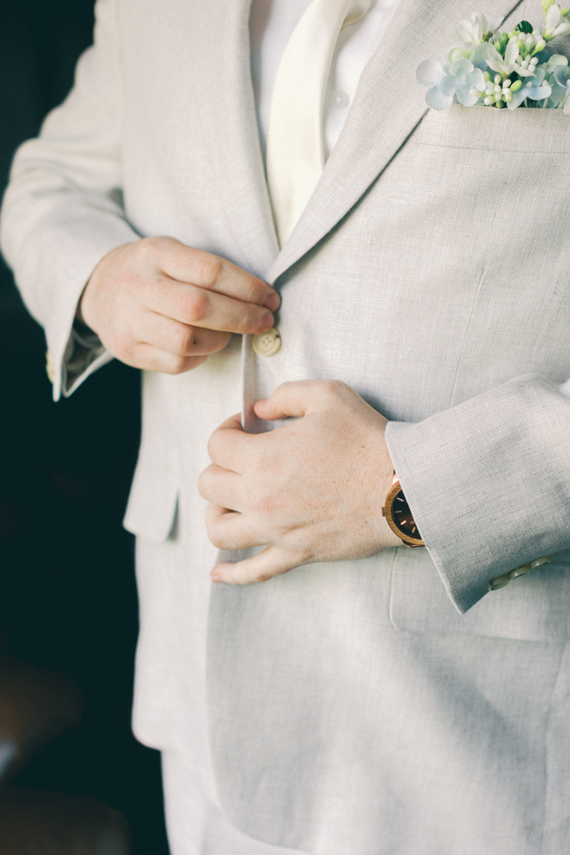 groom putting on coat