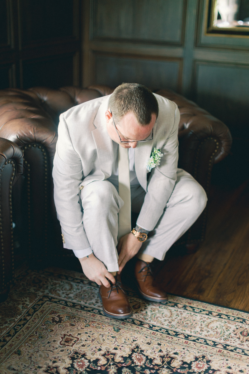groom putting on shoes