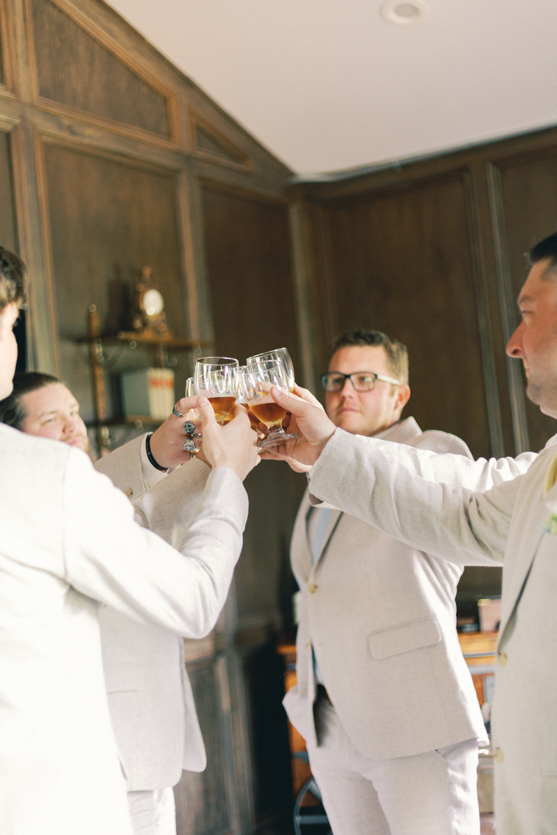 groomsmen cheering with drinks