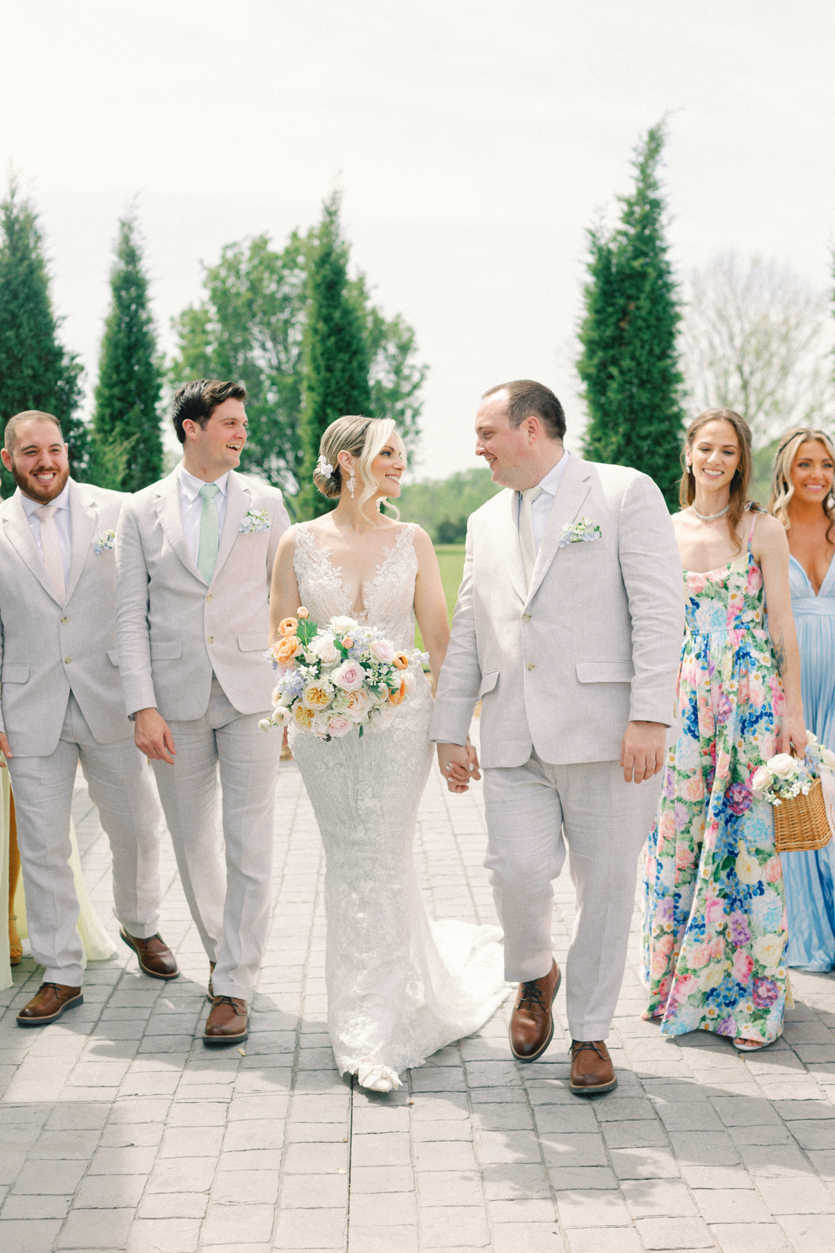 groom and bride walking with wedding party
