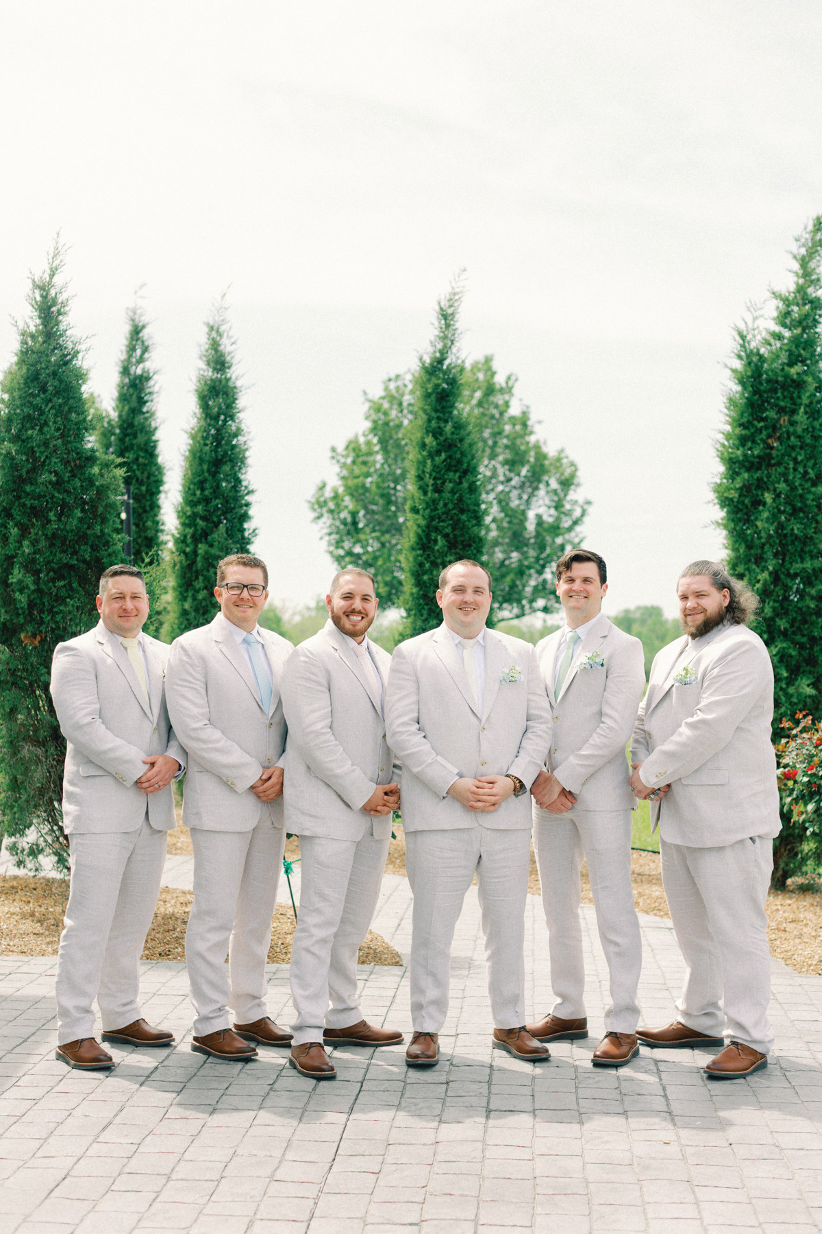 grooms smiling at camera