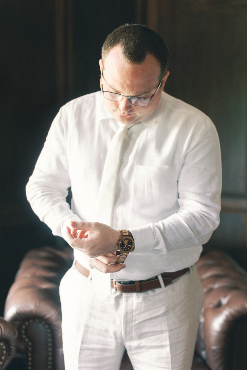 groom putting on watch