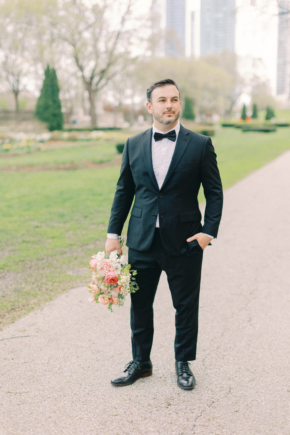 groom holding flowers