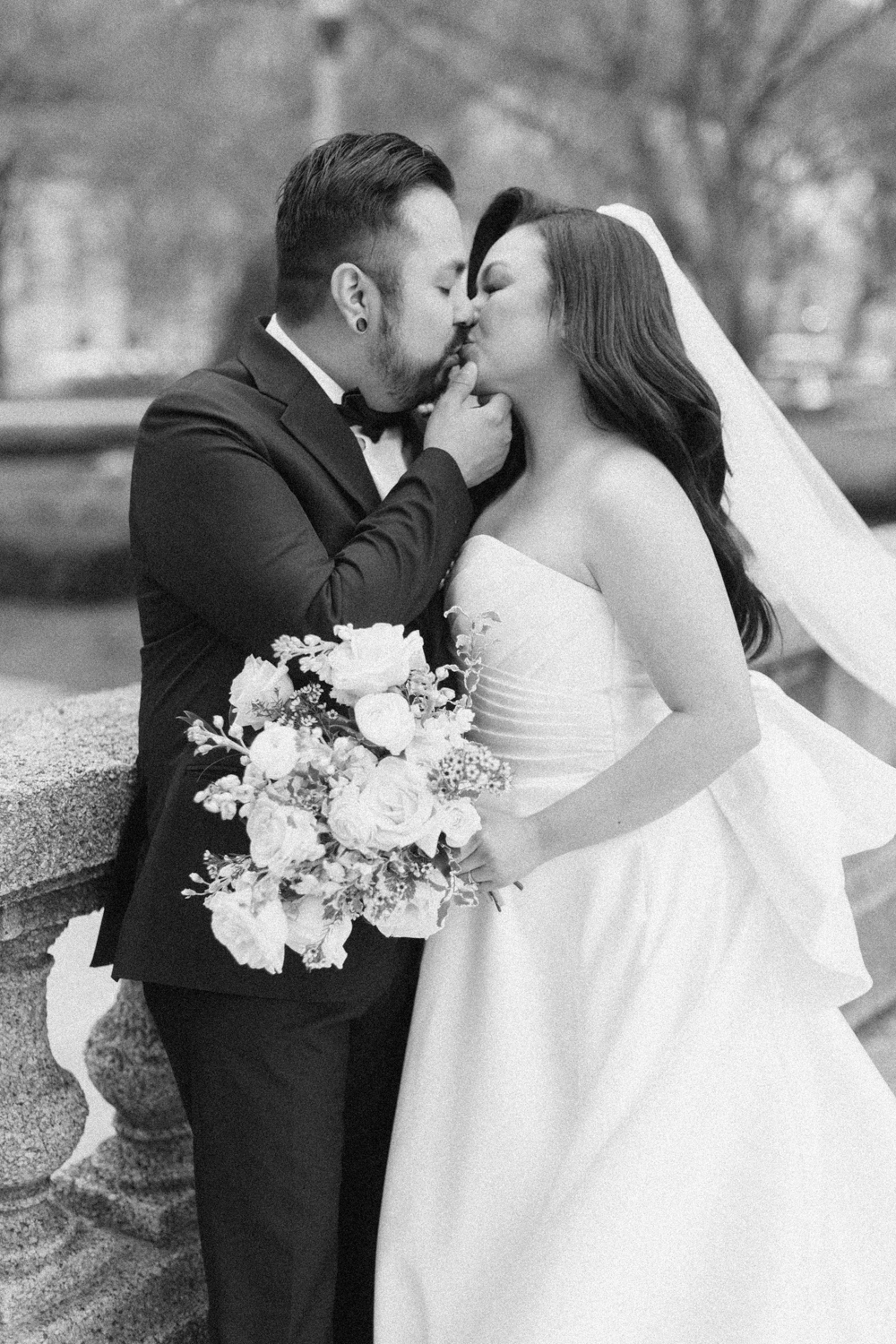 bride and groom kissing black and white