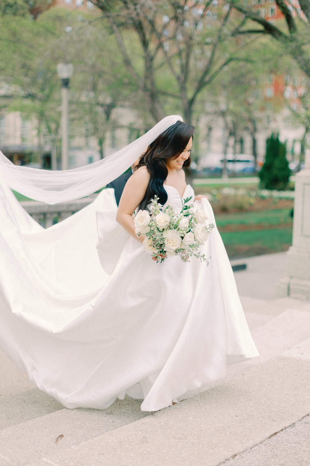bride walking up the stairs outside