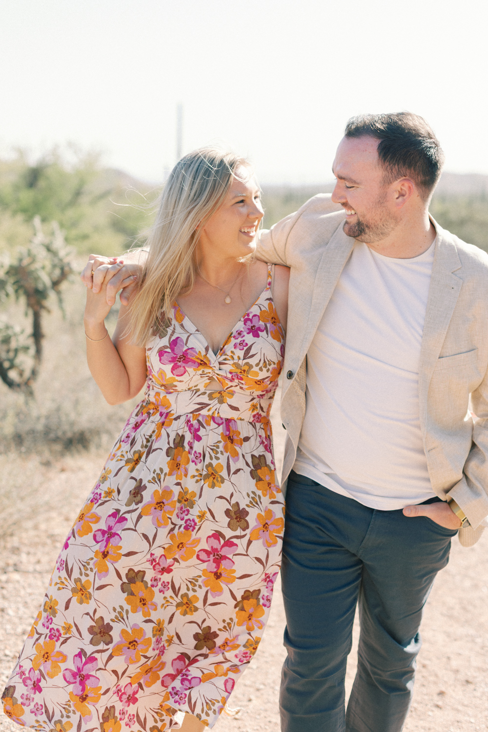 couple walking in desert and laughing