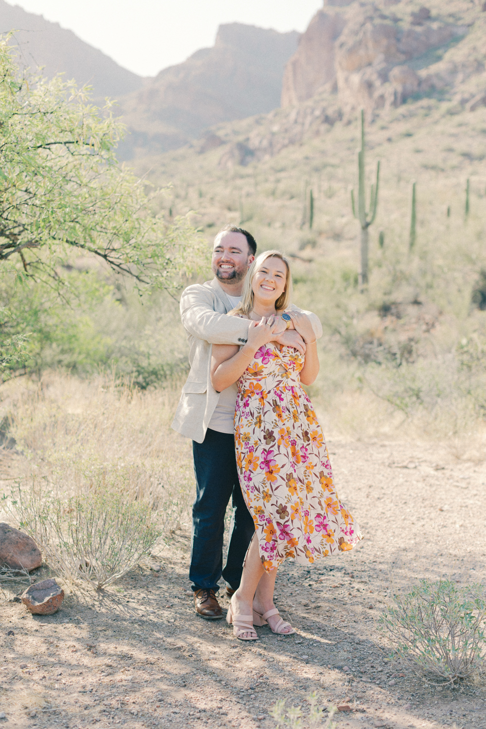 couple snuggled in front of mountain
