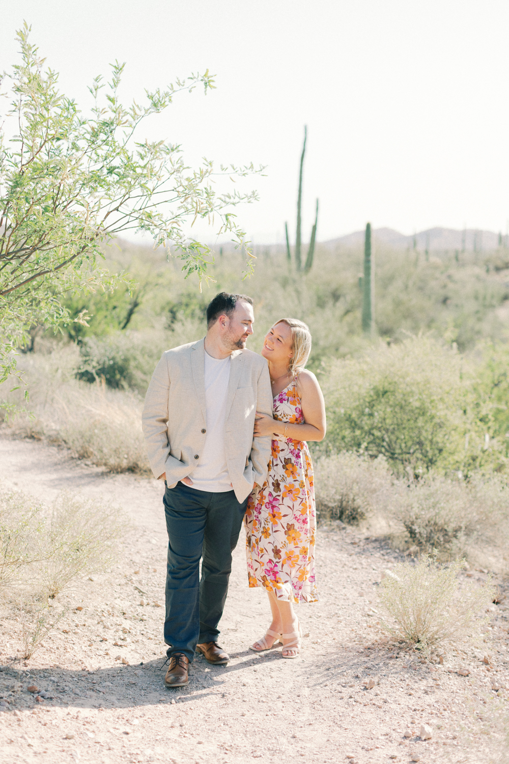 couple snuggled by tree
