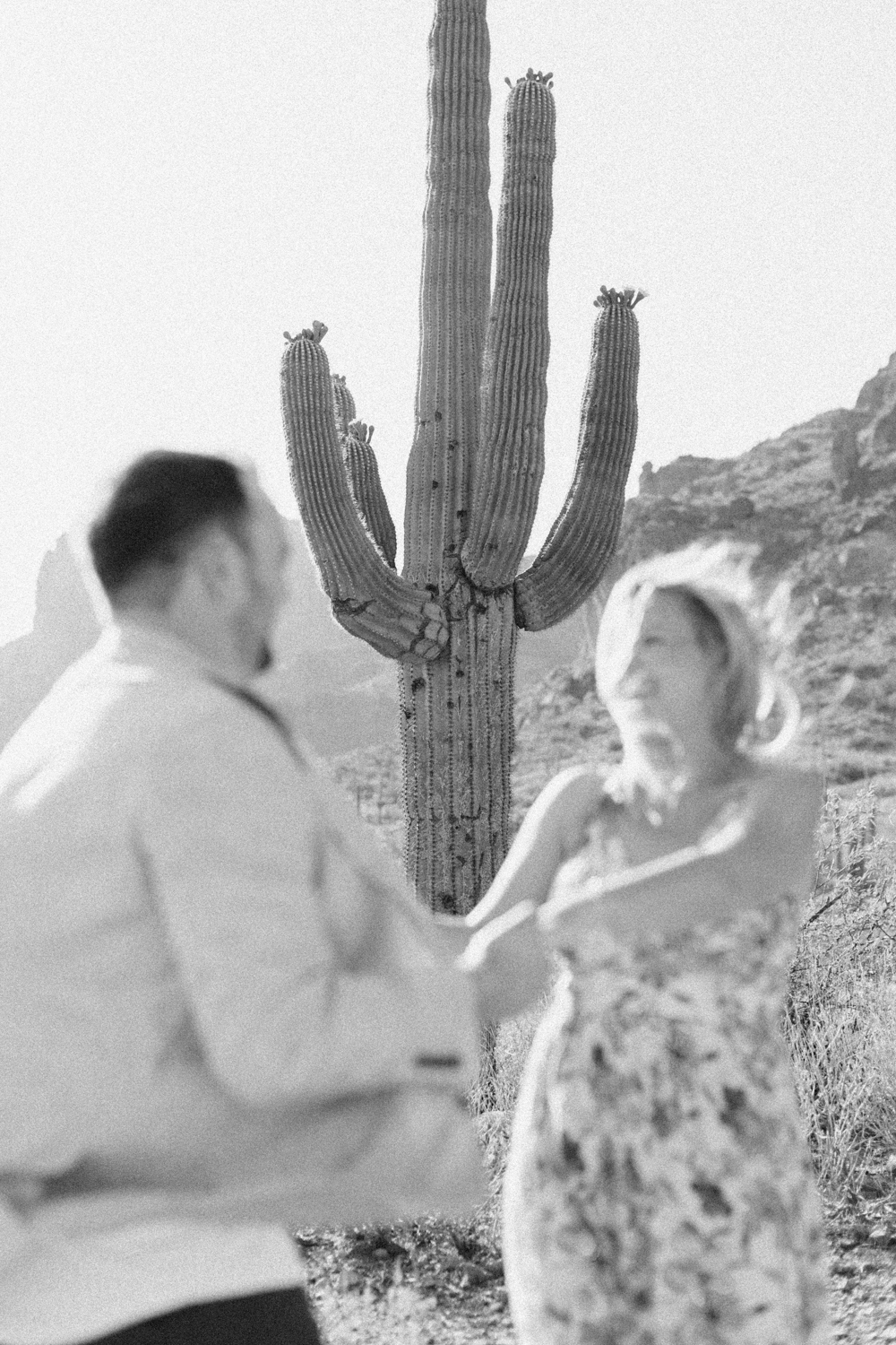 couple spinning in front of cactus