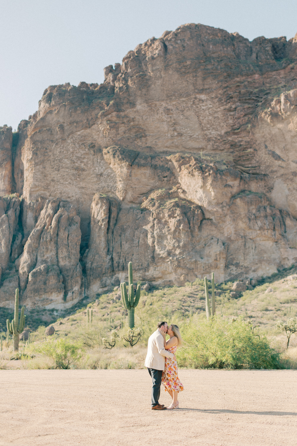 couple kissing in front of mountain