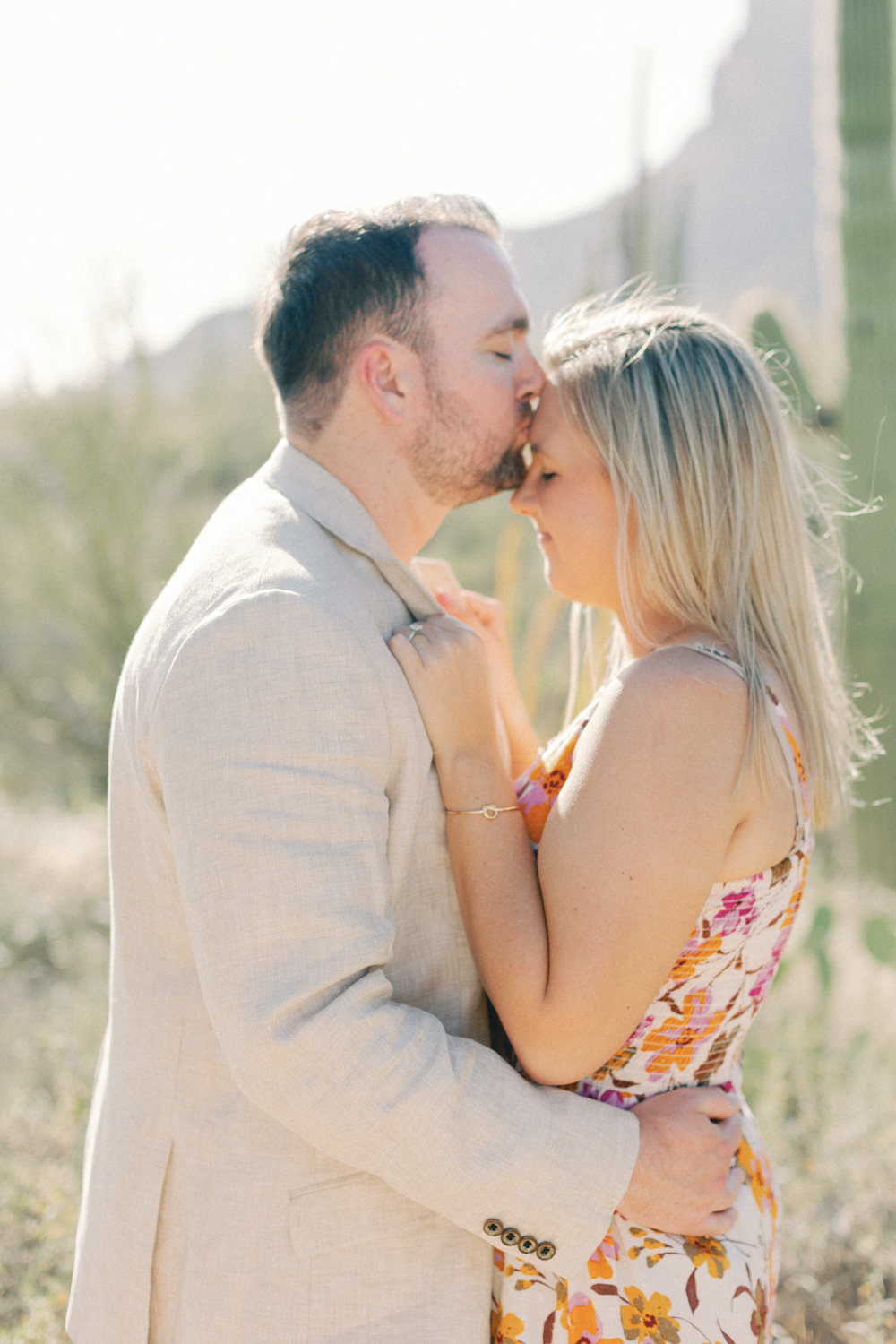 groom kissing brides forehead