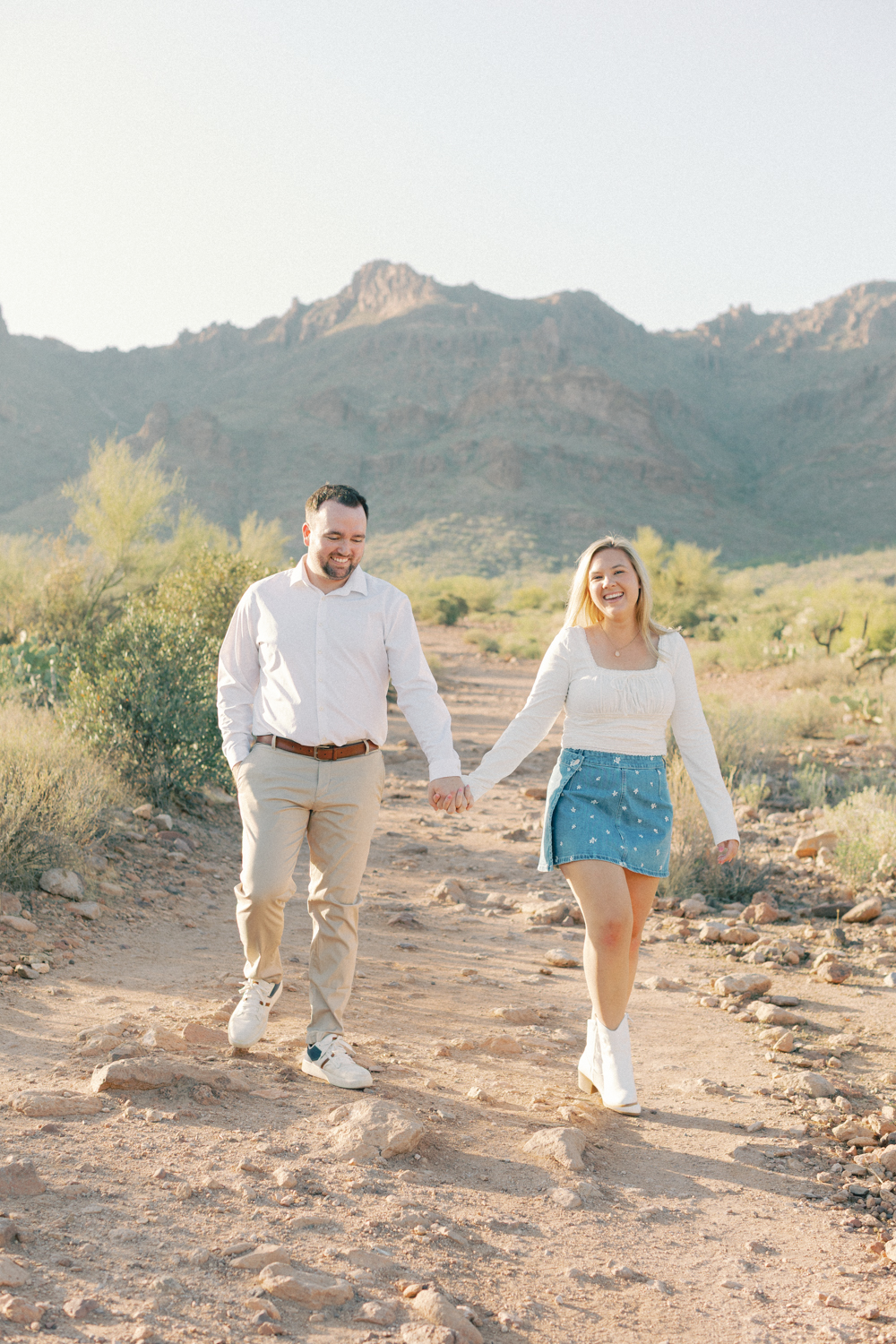 couple walking in desert and laughing