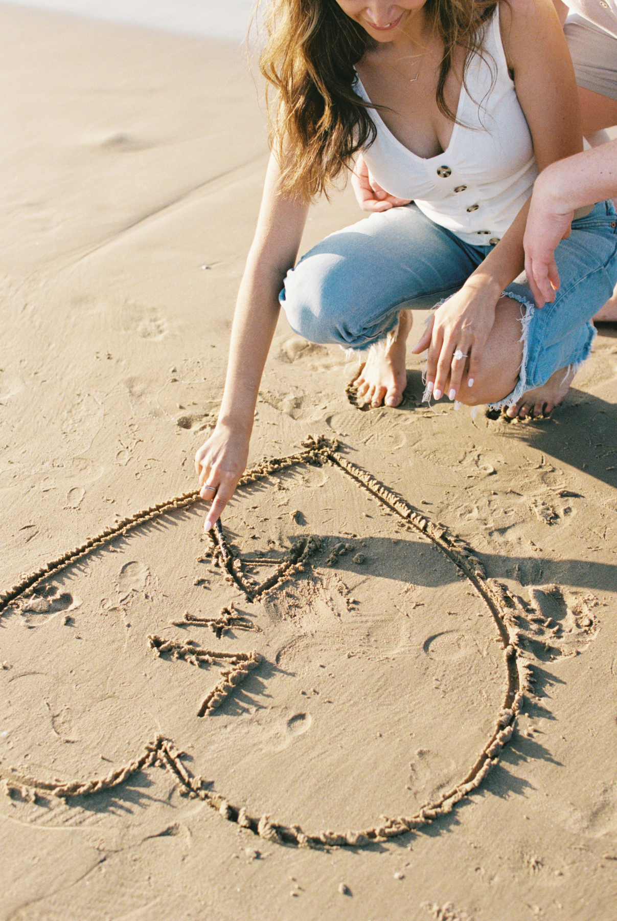 bride drawing in the sand