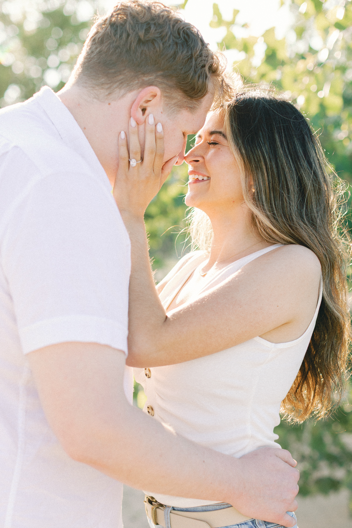 bride holding grooms face