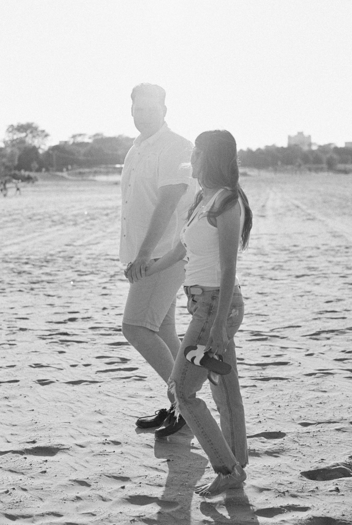couple walking black and white