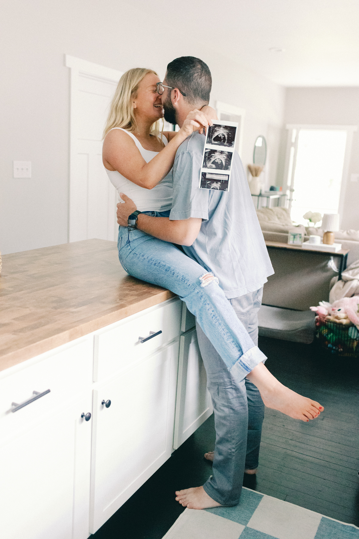 couple on kitchen table with ultrasound picture