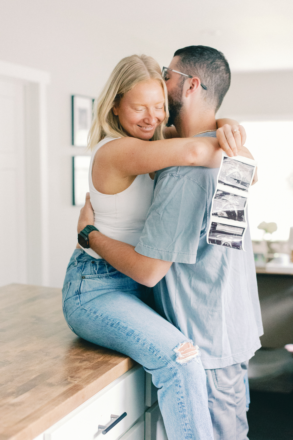 couple on kitchen table with ultrasound picture