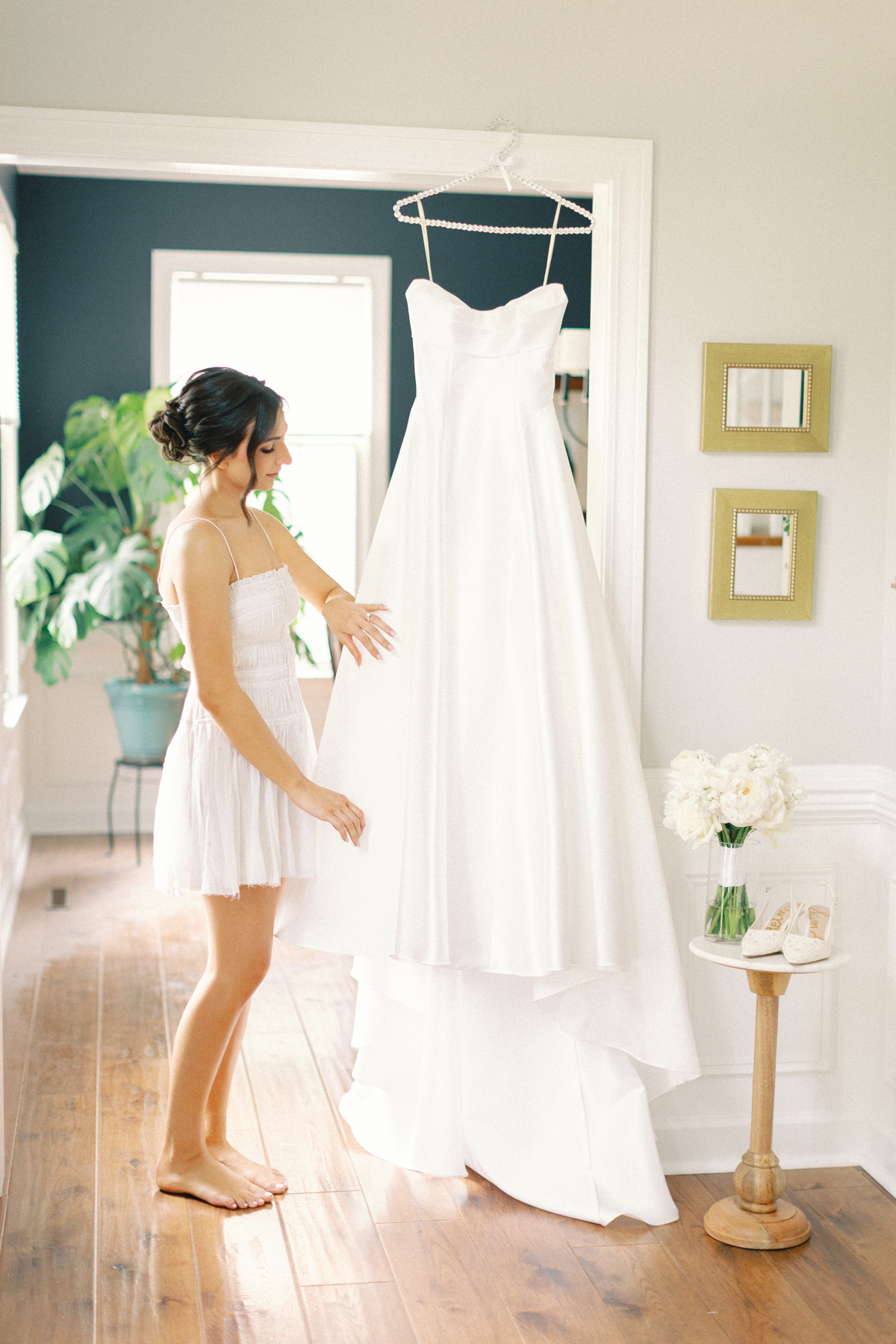 bride holding wedding dress