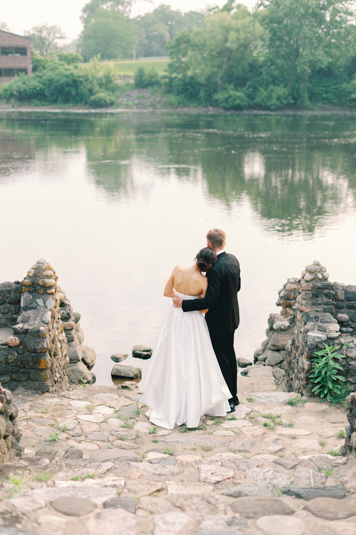 bride and groom by water