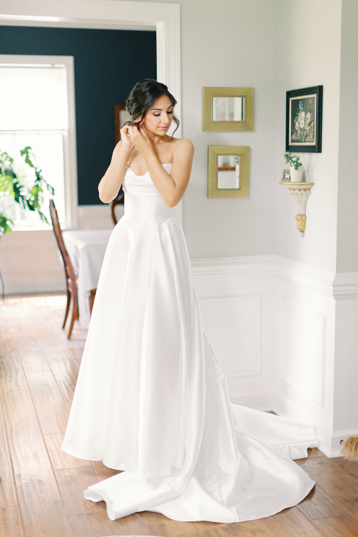 bride putting on earrings