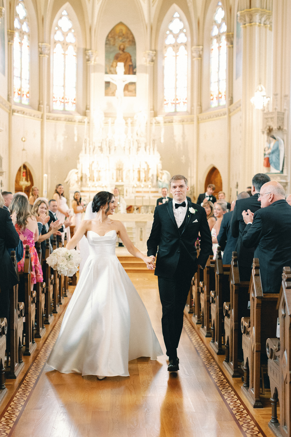 bride and groom walk down aisle