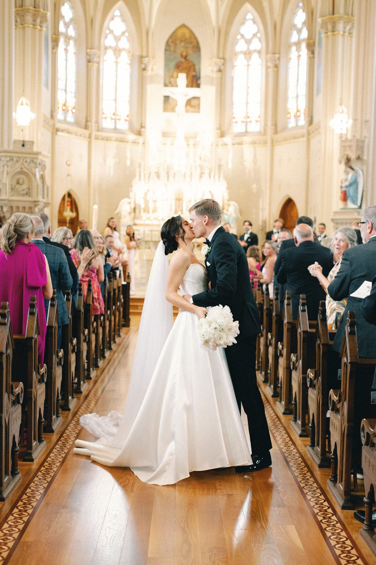 bride and groom aisle kiss