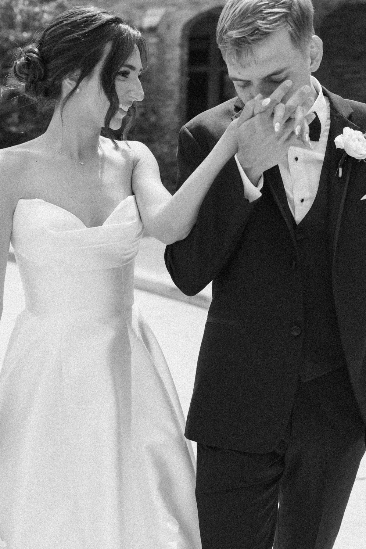 bride and groom kissing hands
