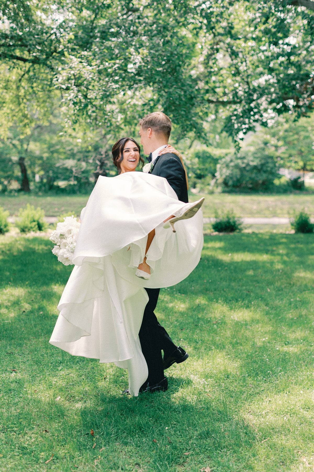 bride and groom spinning laughing