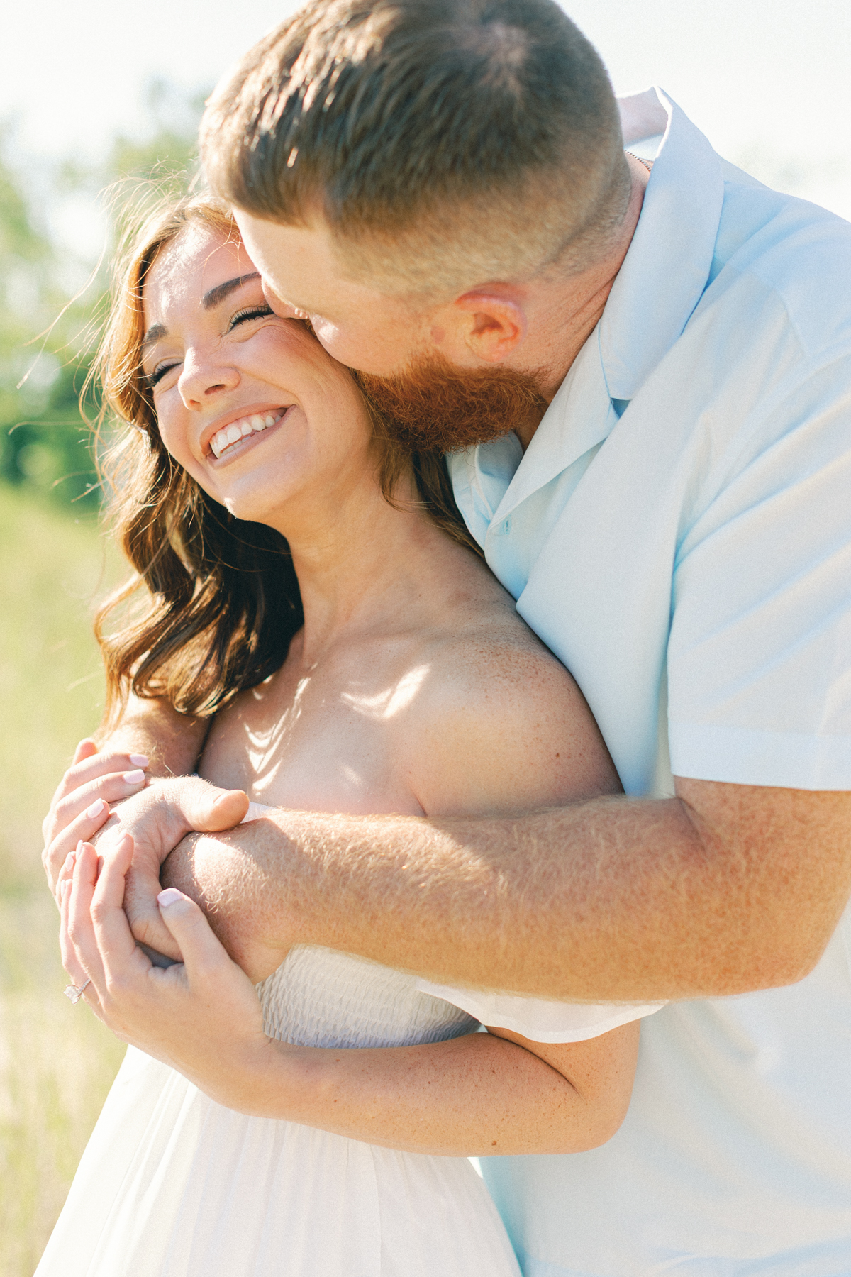 couple holding each other laughing