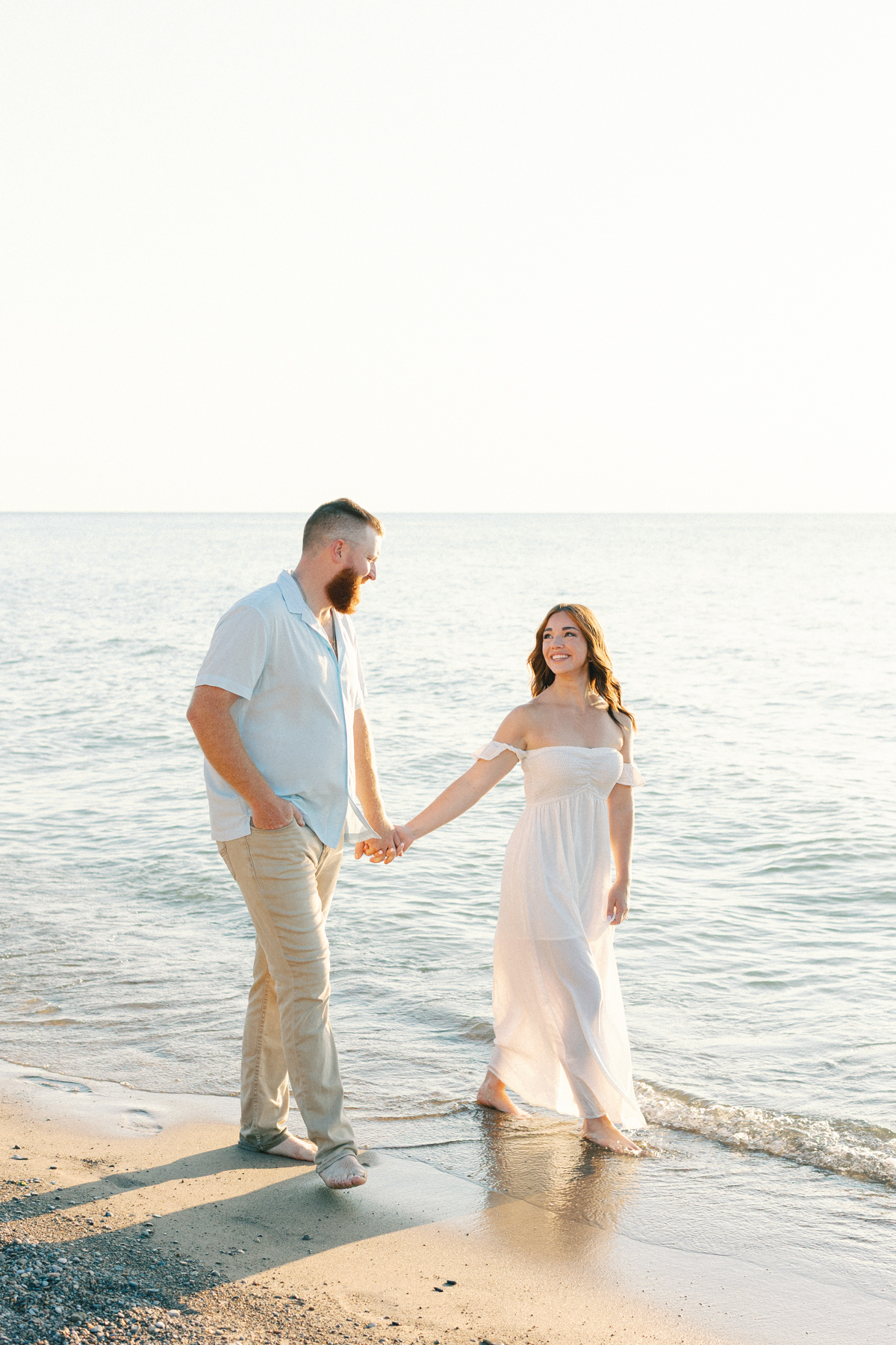 couple walking beach shore