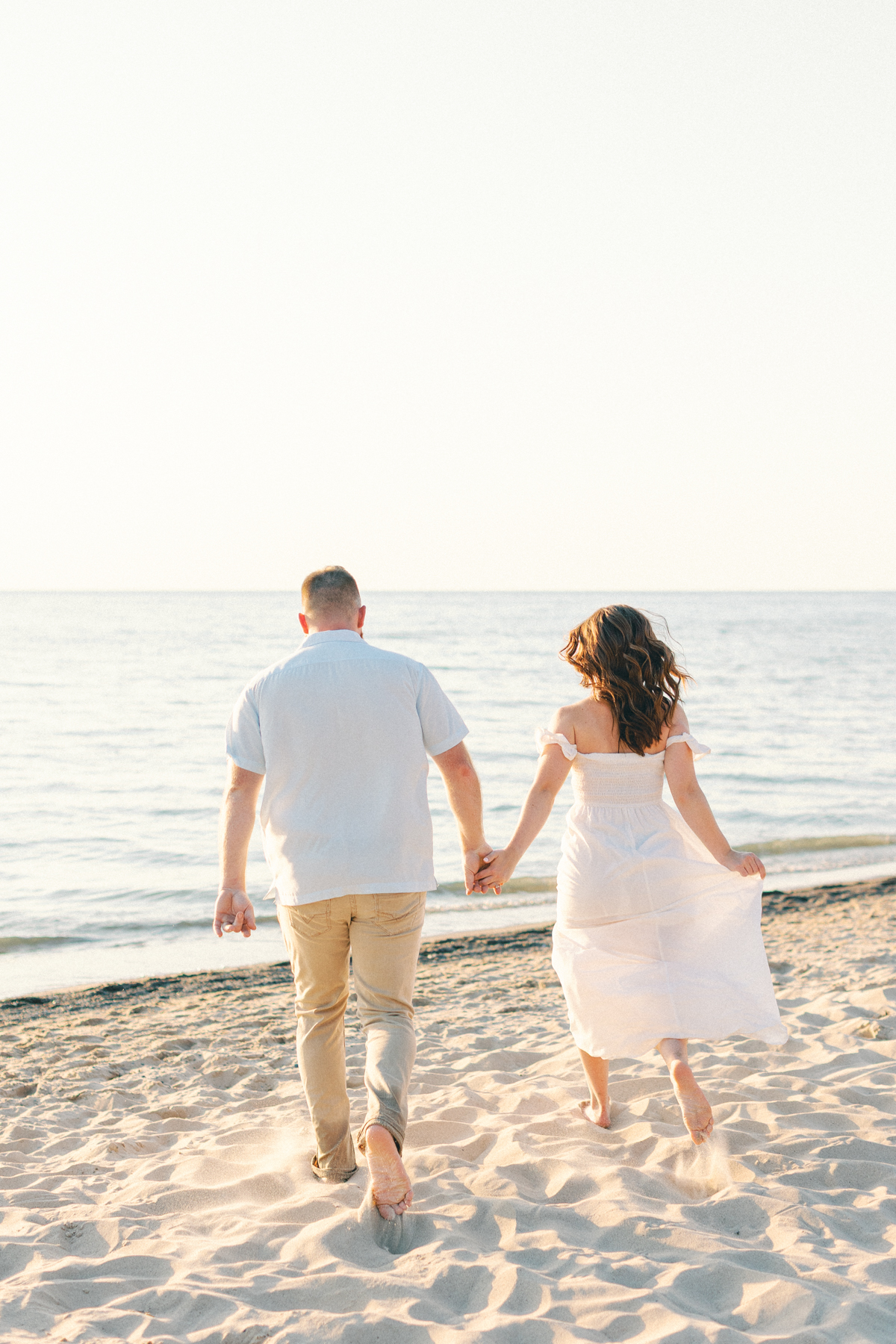 couple running to beach shore