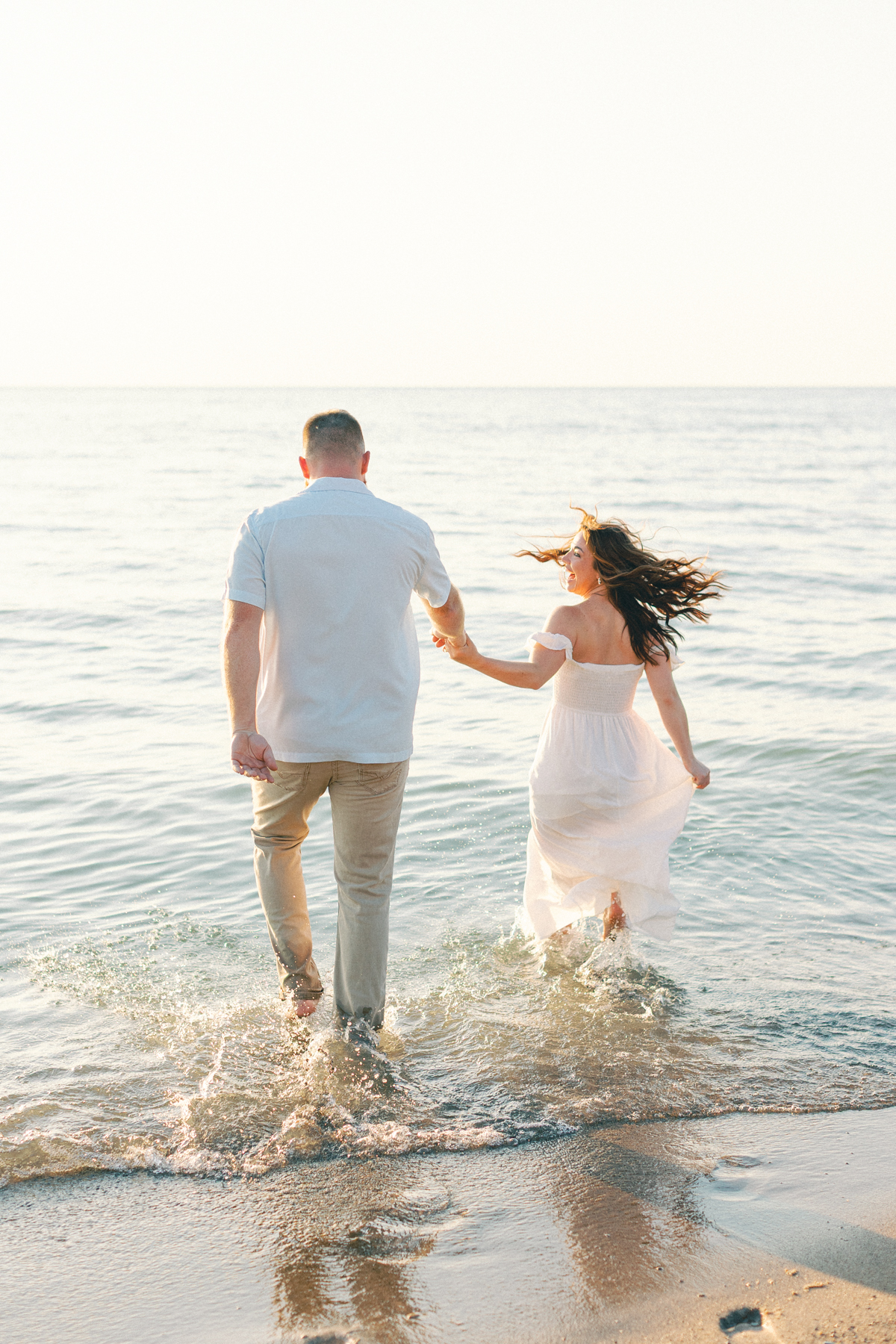 couple running into beach shore