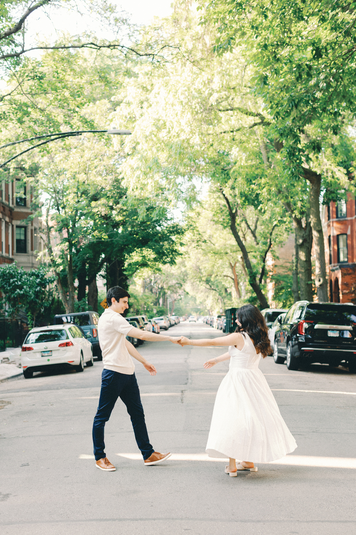 couple twirling in the middle of the street