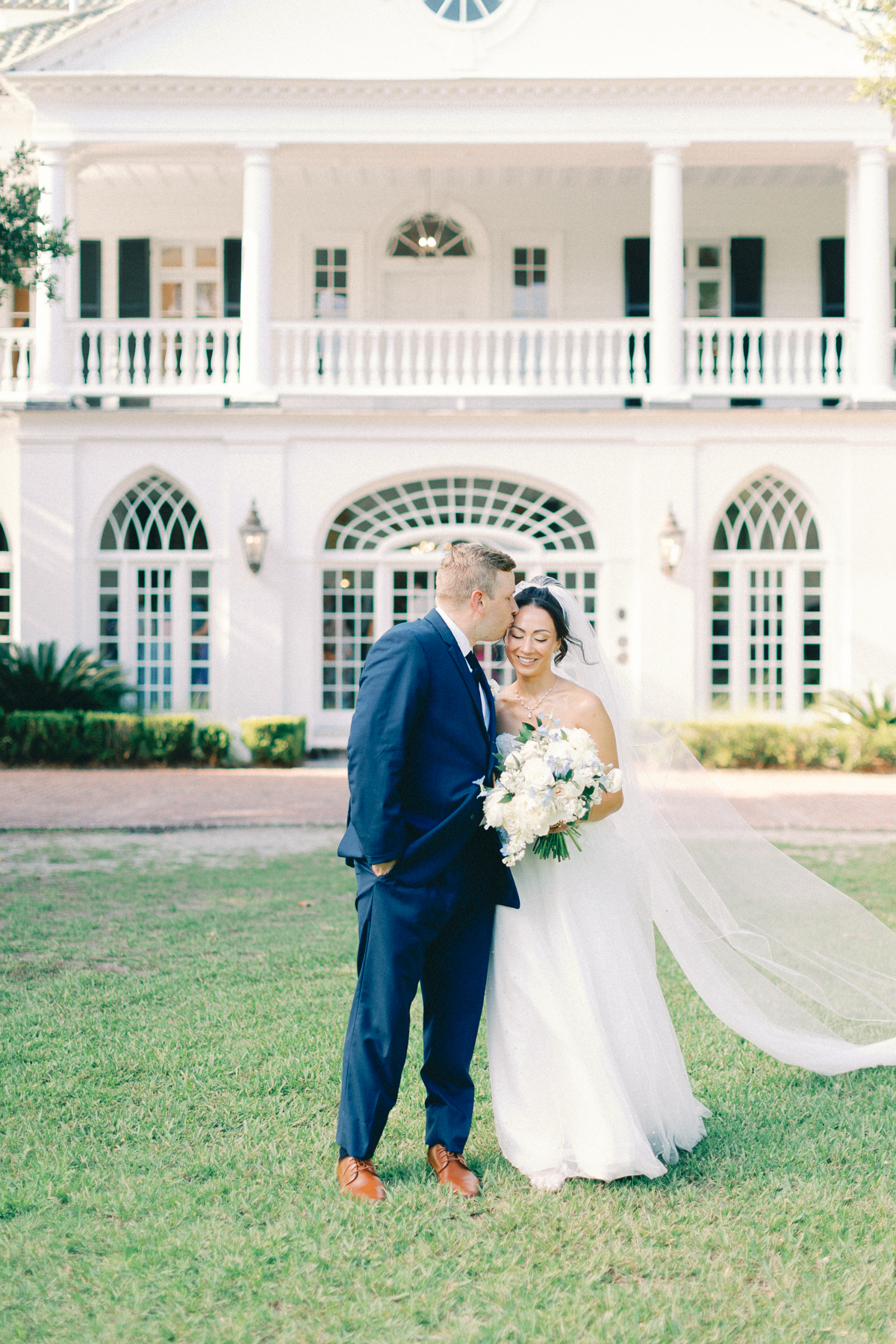 bride and groom walking and kissing