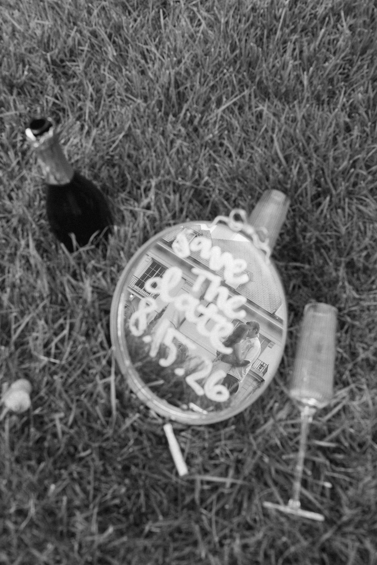  Black and white photo of a mirror with save the date drawn on it