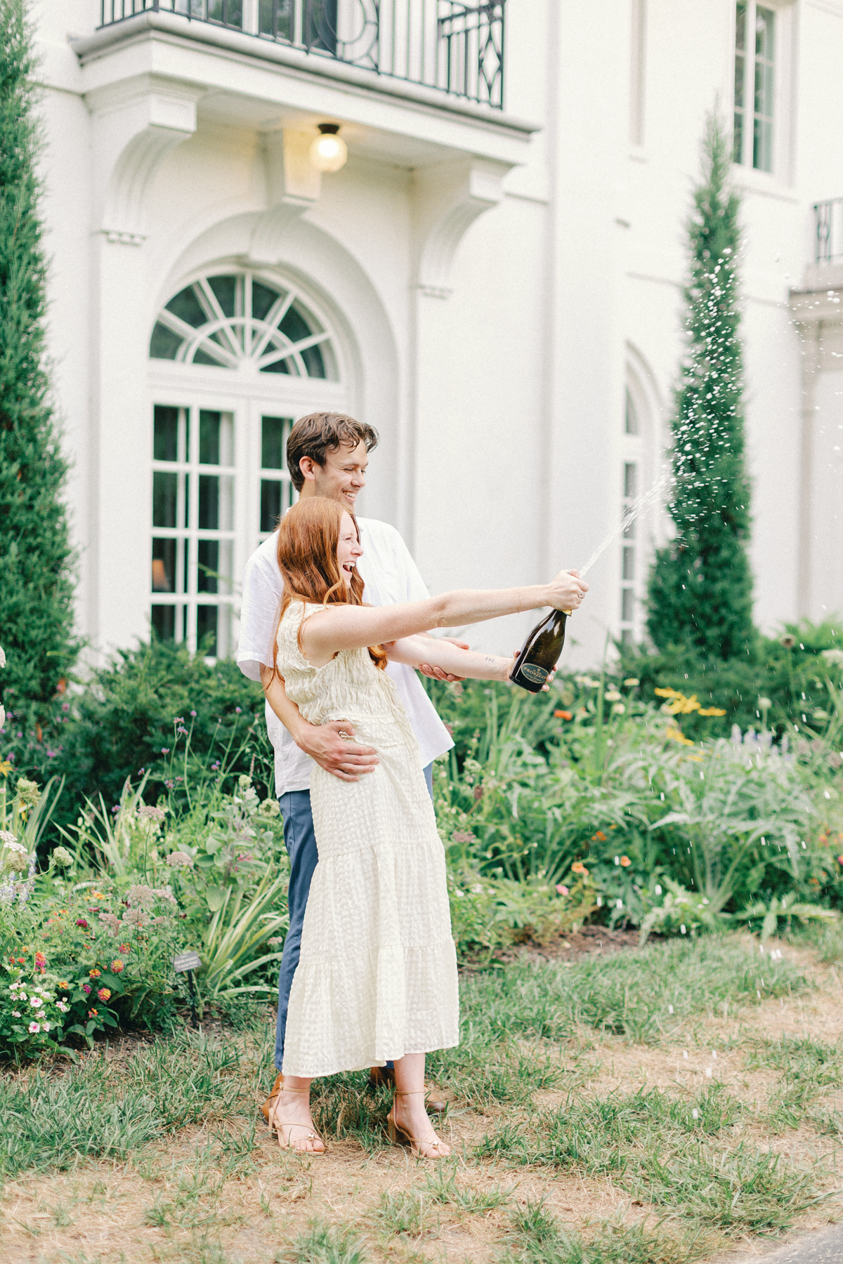  couple popping champagne