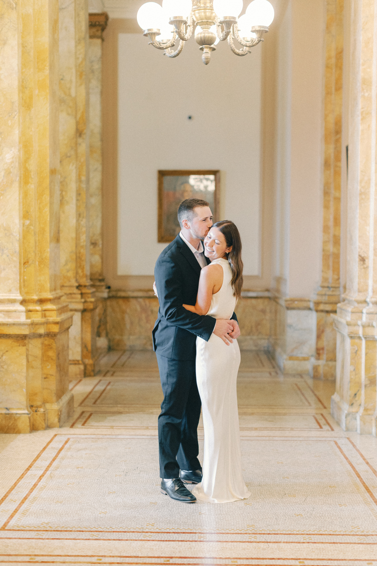 Couple hugging in library aisle