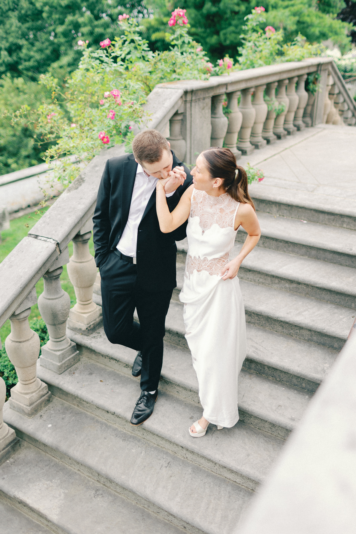 Couple walking downstairs, kissing hand