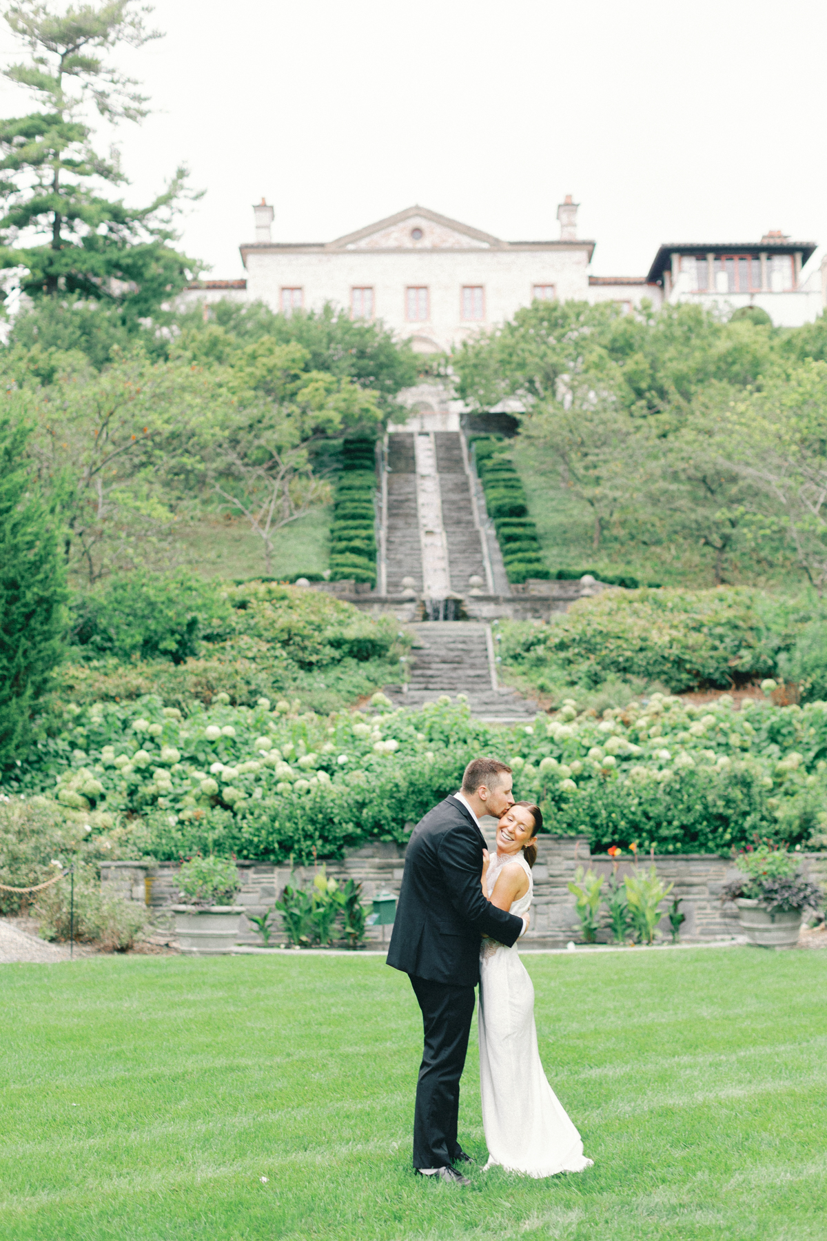 Couple snuggling in front of venue