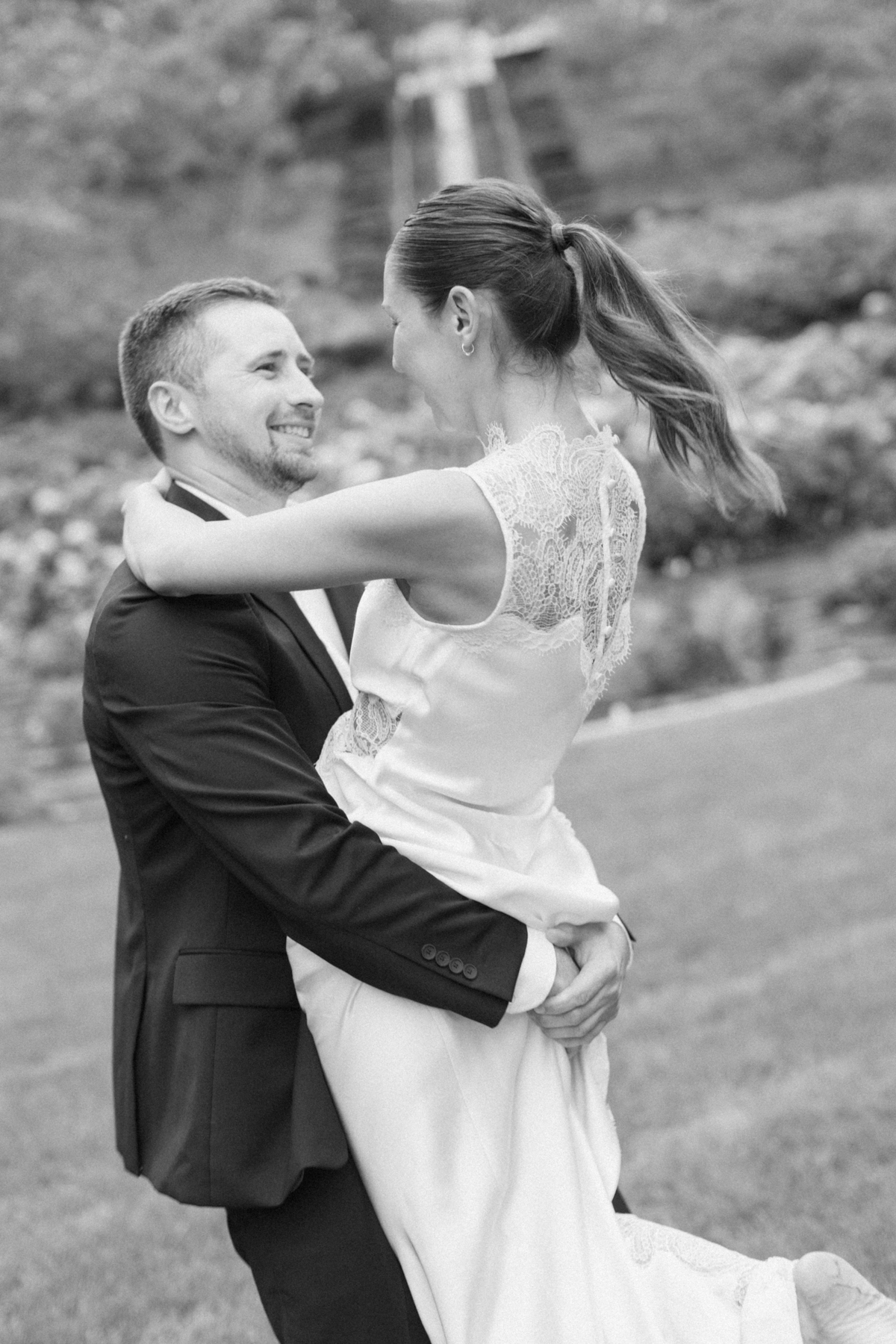 (groom) picking up bride black-and-white