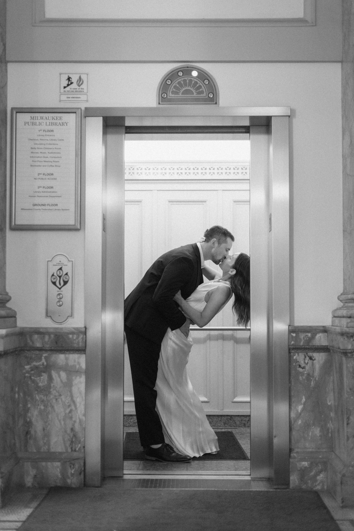 Black-and-white photo of couple in elevator