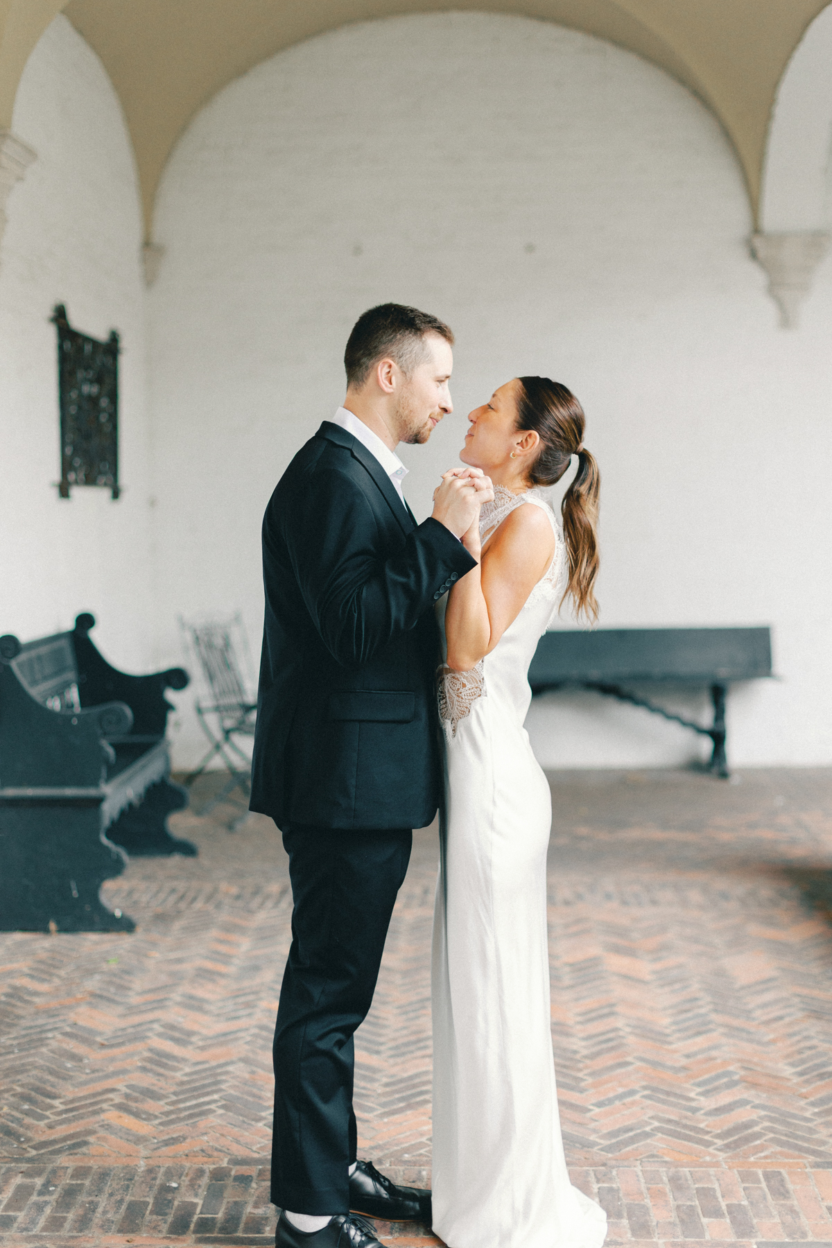 Couple holding hands and hallway outside